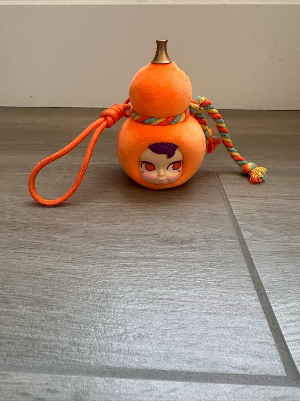 Orange Plush Gourd Toy with Face and Rope Handle